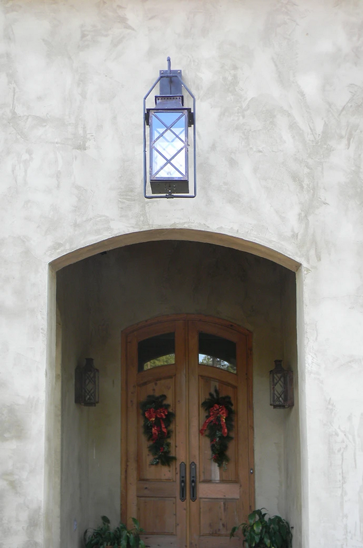 Aspen wall mounted lantern with a full yoke hangs above a doorway