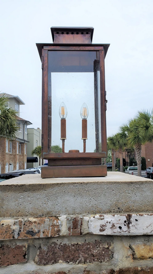 The Aspen lantern featured outside as a pier mount with a dual candelabra on the inside
