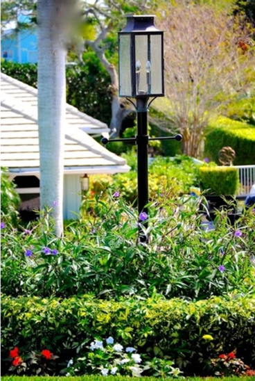 The Aspen lantern featured outside as a post mount with dual candelabras and ladder rests