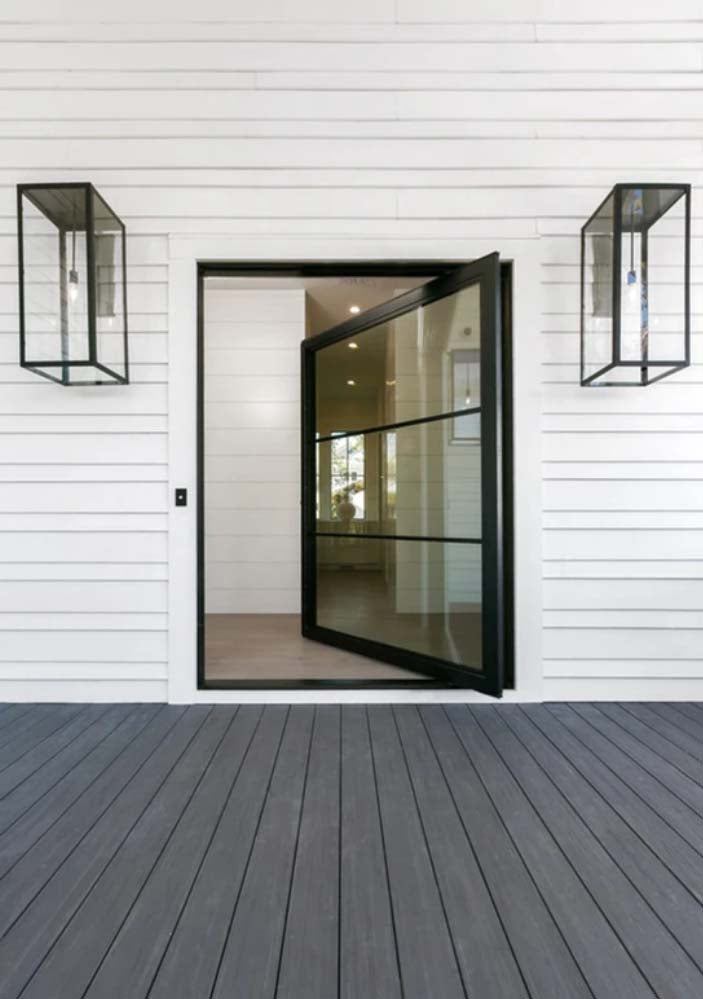 Black finished Ashley lanterns mounted outside of a doorframe with a slightly open glass door