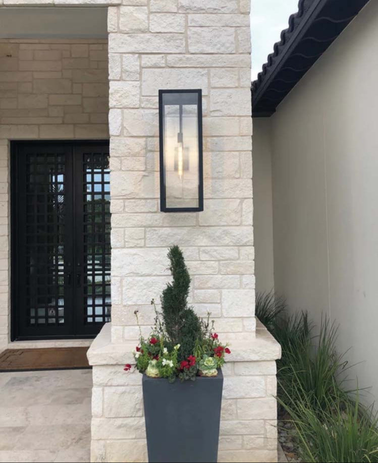 The Ashley lantern featured hanging on a stone wall outside