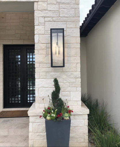 The Ashley lantern featured hanging on a stone wall outside