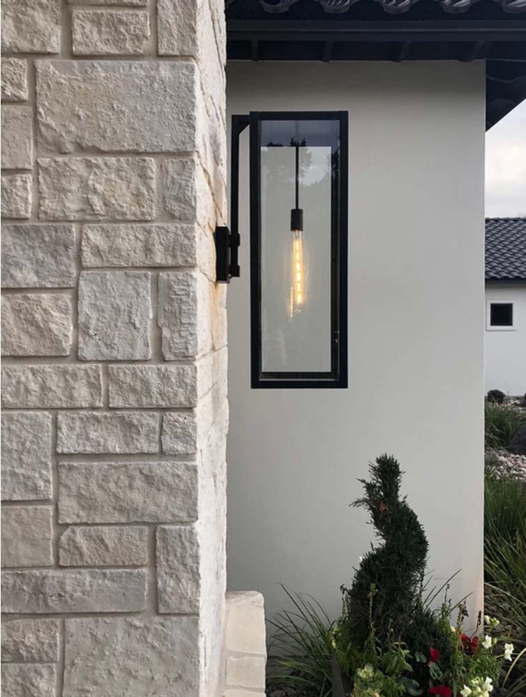 The Ashley lantern featured hanging on a stone wall outside