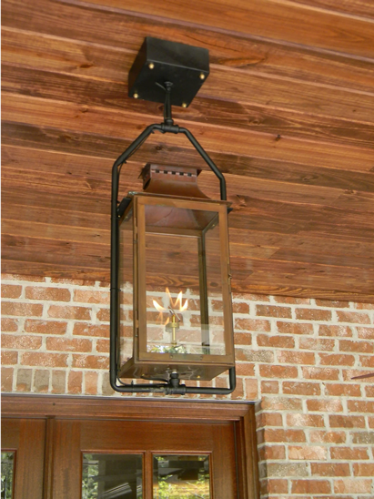 A Copper Aspen lantern using gas is hanging from the ceiling with a full yoke mount