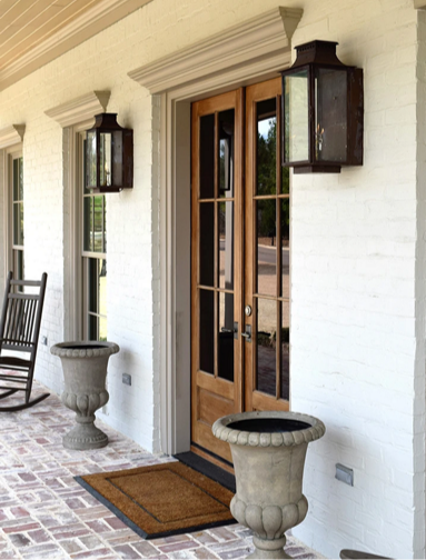 Side view of a copper Aspen lantern hung outside of a front door