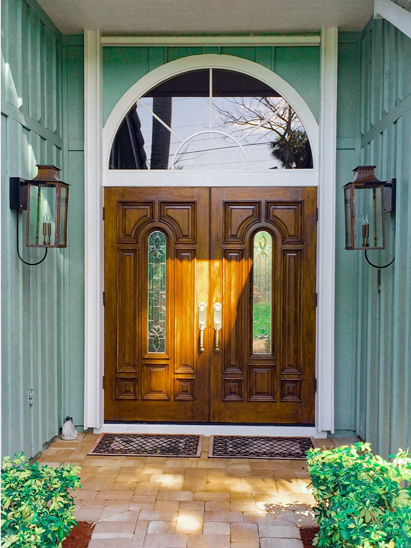 Two copper Aspen lanterns hanging on either side of a double doorway. 
