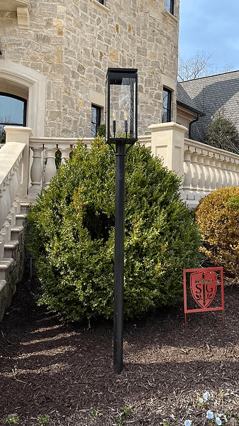 Example of the Frisco wall lantern outside on a steel straight yard post mount