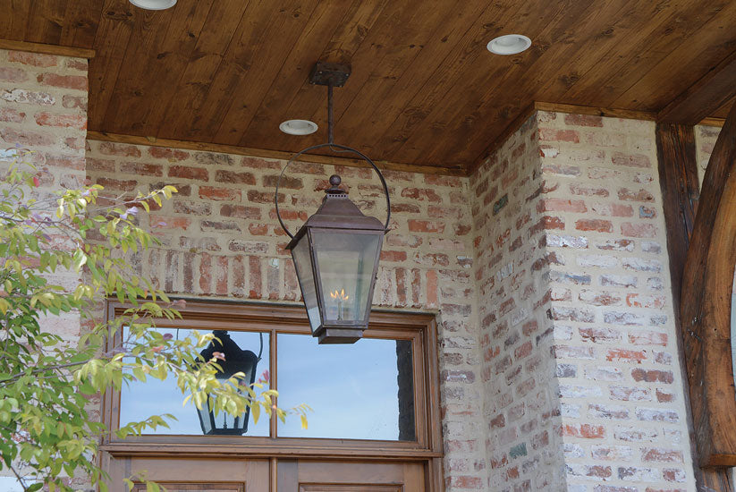 An example of a lantern fixture being hung outside with a half yoke ceiling mount