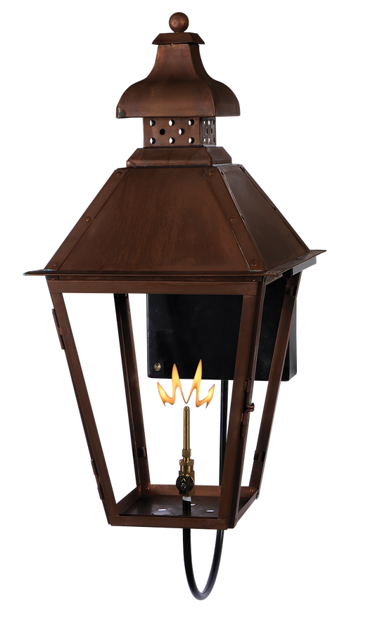 A copper Logan wall mount lantern with a gas powered lighting feature
