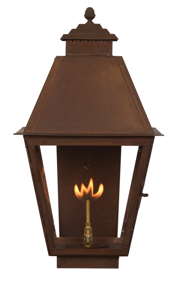 A copper Natchez wall lantern with a gas lighting feature
