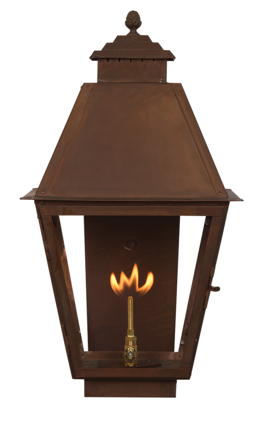 A copper Natchez wall lantern with a gas lighting feature
