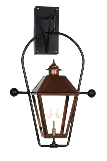 A copper lantern with a gas lighting feature hangs from the wall in a full yoke style