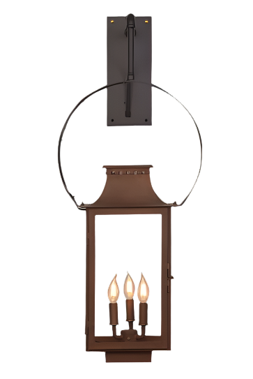 A copper lantern with triple candelabra hangs from a wall mount in a half yoke style
