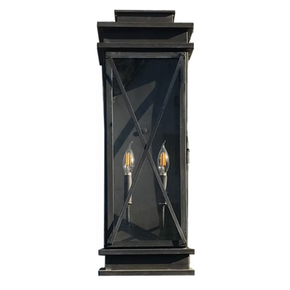 A dark colored lantern is featured with crossing window straps across the glass with a double candelabra